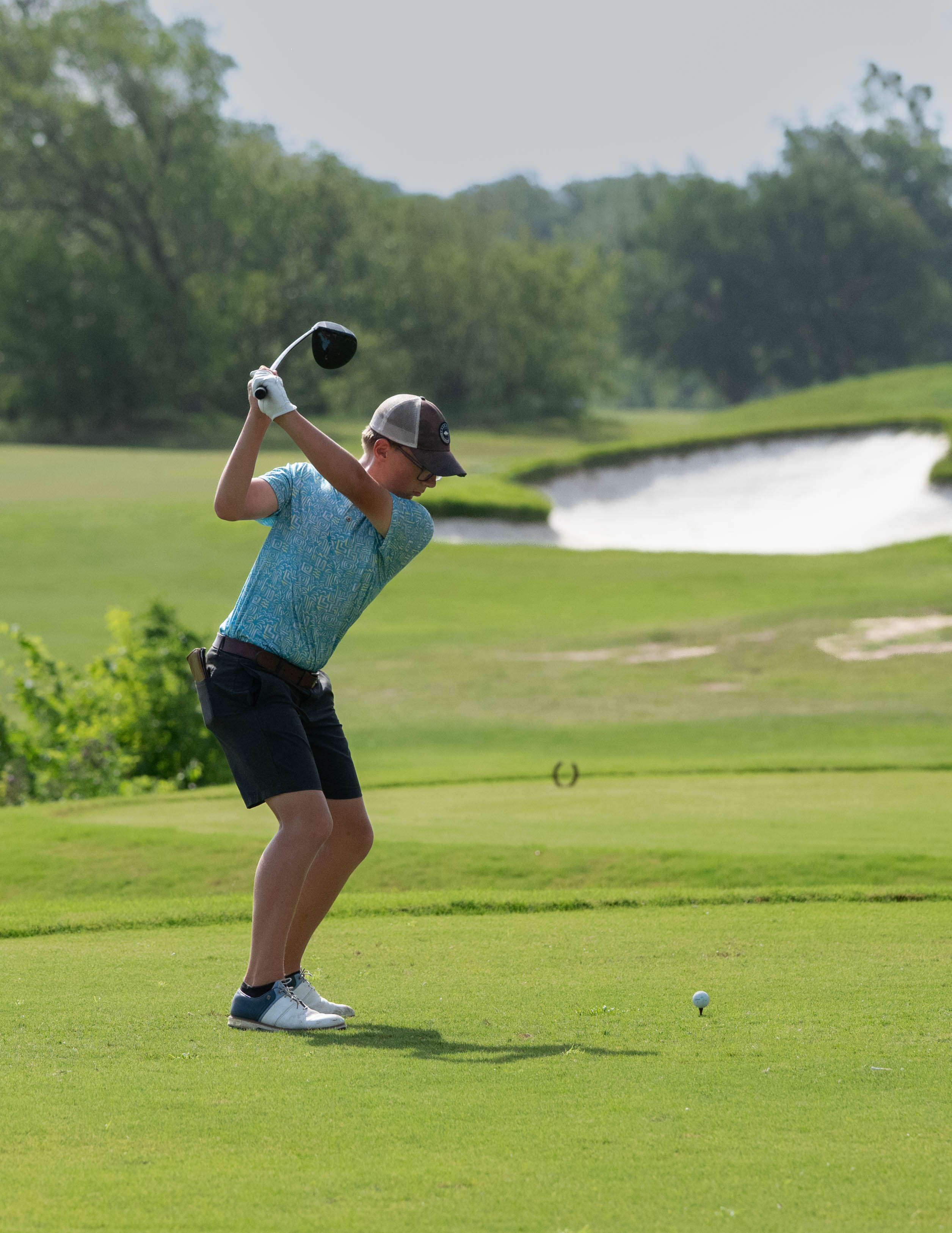 Zachary playing golf
